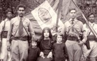 Rosario de madera y Biblia apoyados sobre la bandera histórica mexicana de la Guerra Cristera.